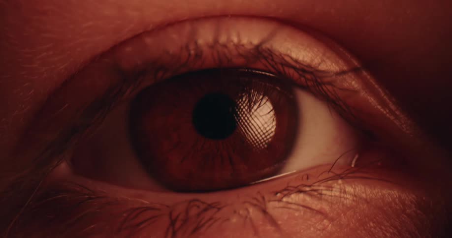A close up of a persons eye in a room