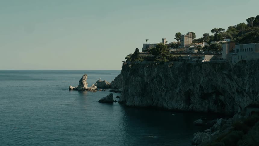 Houses and buildings on a mountain overlooking the water along the coast