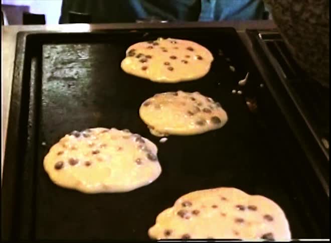 Man in the kitchen preparing pancakes