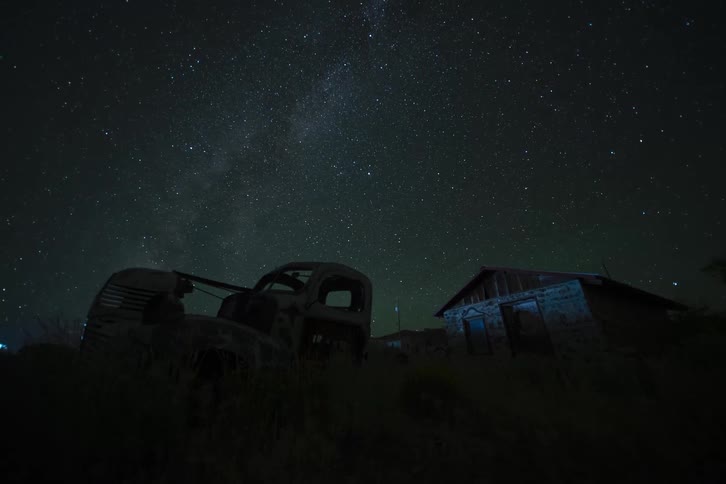 Starry night sky with a house in the background