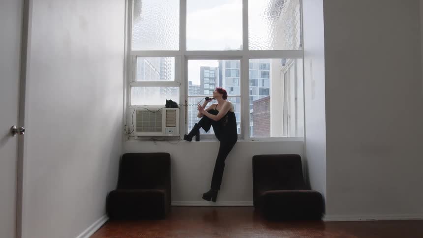 A portrait of a woman sitting in a window