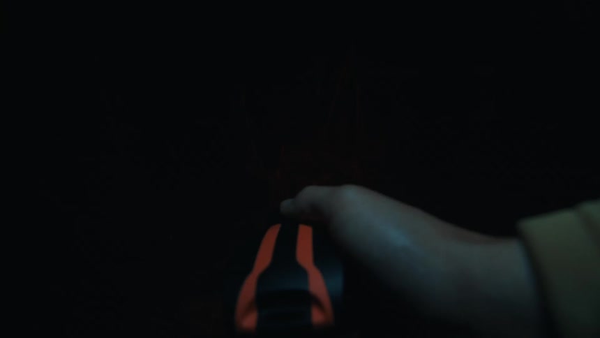 A person walking through a forest at night