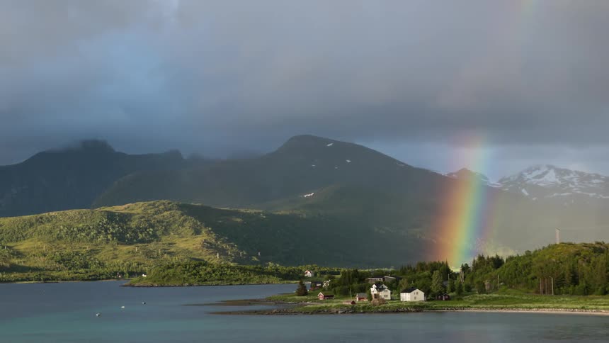 A rainbow rises above the bay ahead