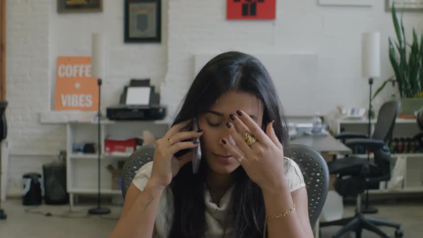 The office worker listens on her cell phone