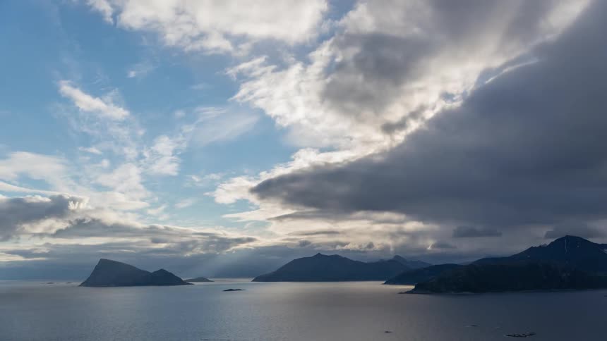 Heavy clouds move fast over the sea and mountain islands
