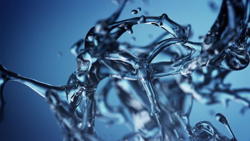 Crystal clear water splashes and twists slowly against a blue background