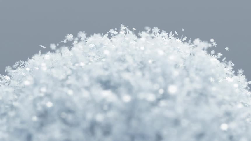 White snow flakes fly off a rotating sphere