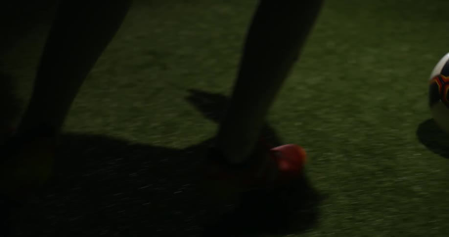 Legs kick a soccer ball