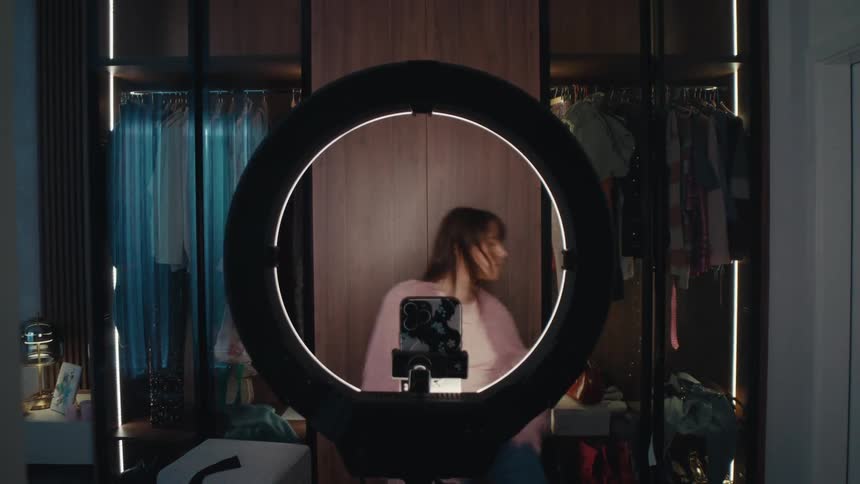 Woman dances in front of a phone mounted on a tripod