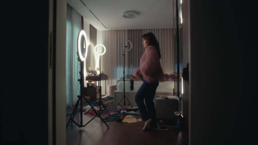 A woman modeling clothes in a room