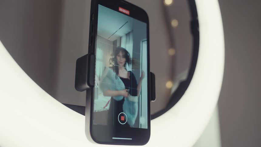 Person records herself with a smartphone before turning off the record function