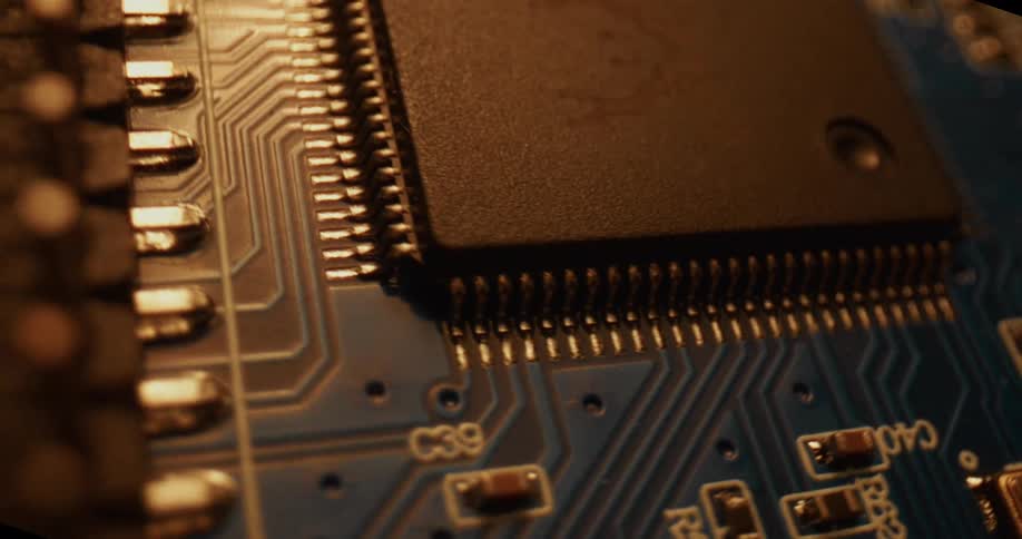 Microchip mounted on a circuit board with visible electronic traces