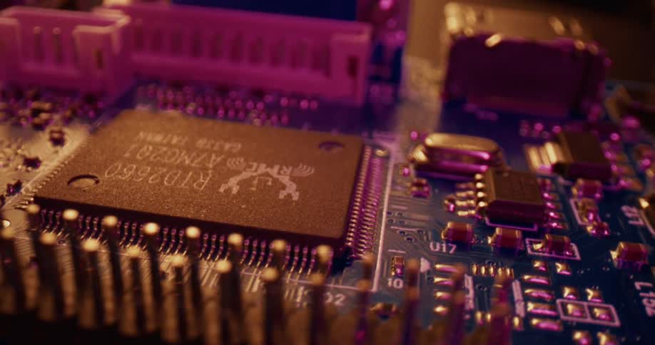 Microchip soldered on a circuit board with surrounding electronic components