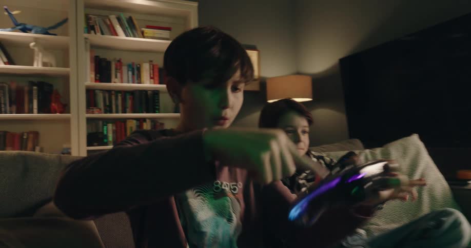 Two children are playing video games at home