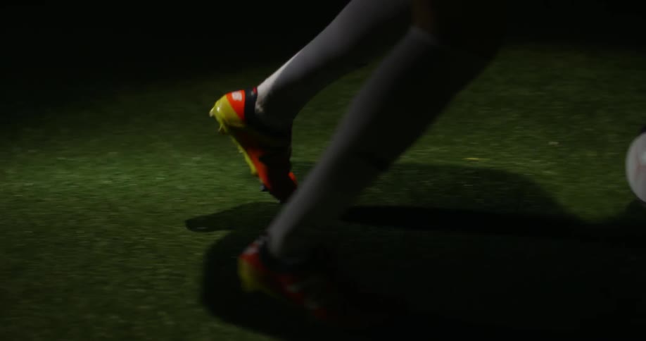 A soccer plays kicks a ball around