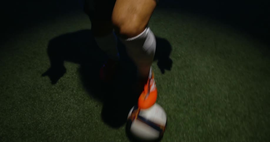 A man dribbles a soccer ball