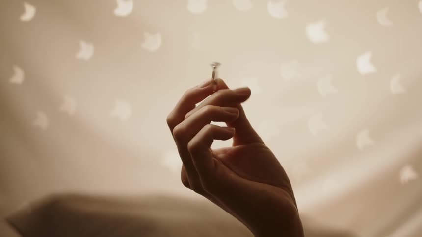 A woman twirls a ring in her hand