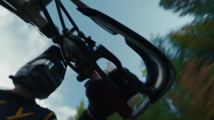 The man applies pressure to the gas on his dirt bike as he speeds