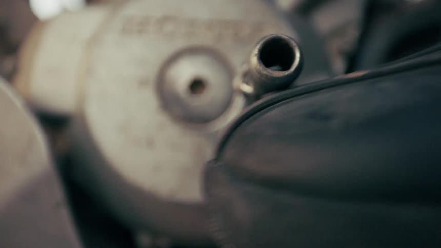 A person uses their foot to move a lever on a machine