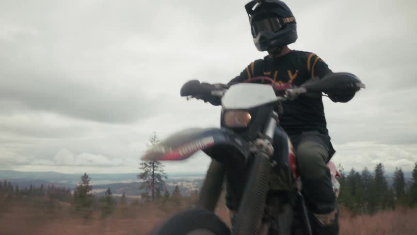 A man riding a dirt bike outdoors