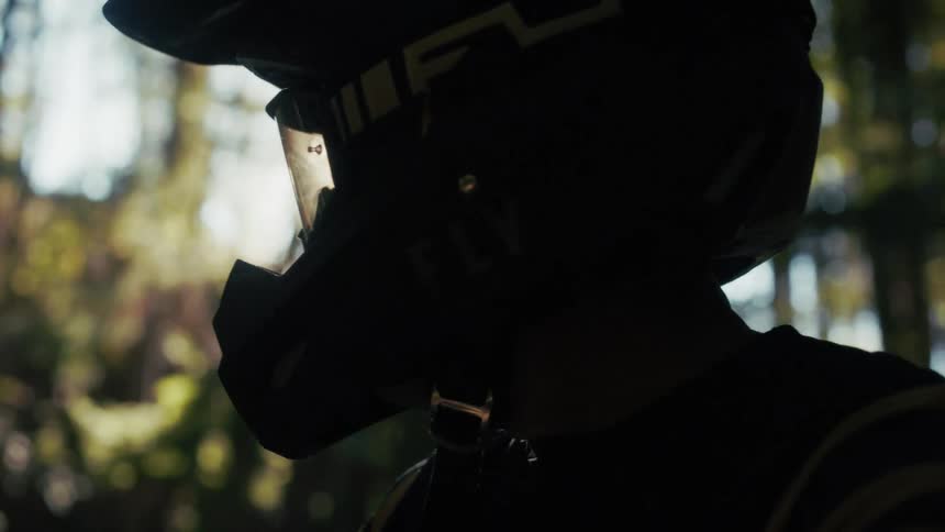 The first is the strong horizontal line formed by the top edge of the helmets goggles this line creates a clear division between the visor of the helmet and the reflective surface of the lens serving as a focal point in the silhouette
