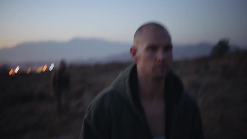 A man walks away from a woman in a rural area