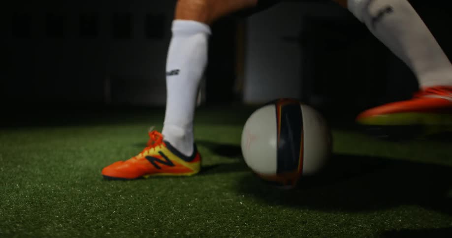 A man dribbles a soccer ball