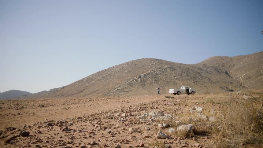 A man walks on the desert ahead