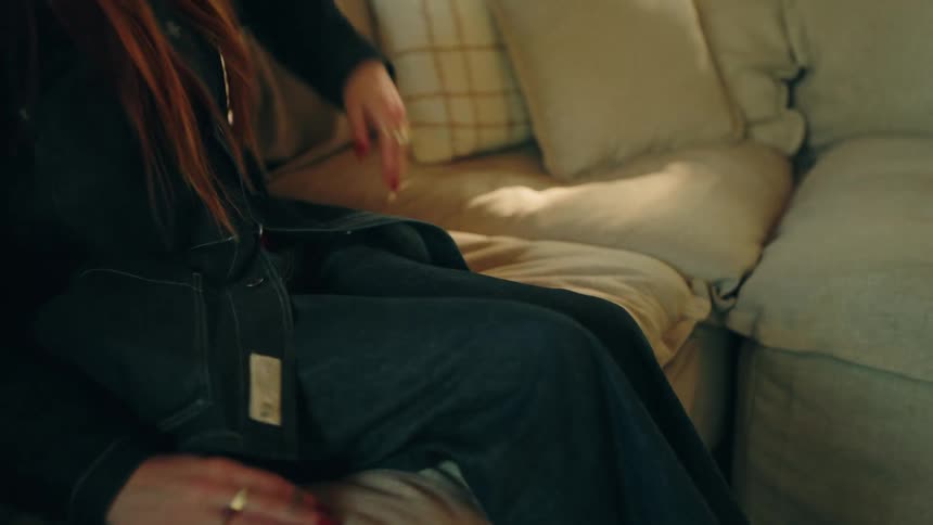 A woman sitting down on a couch