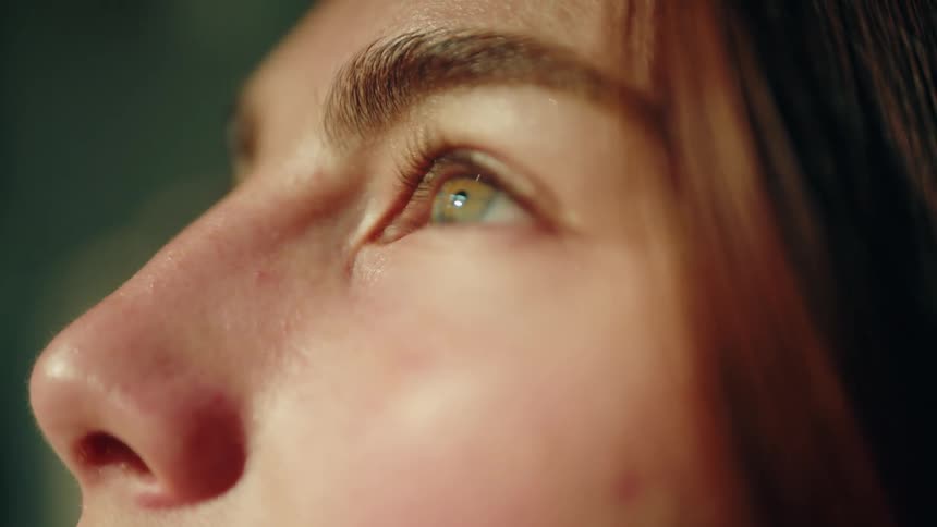 Female eye bathed by sunlight outdoors during day time