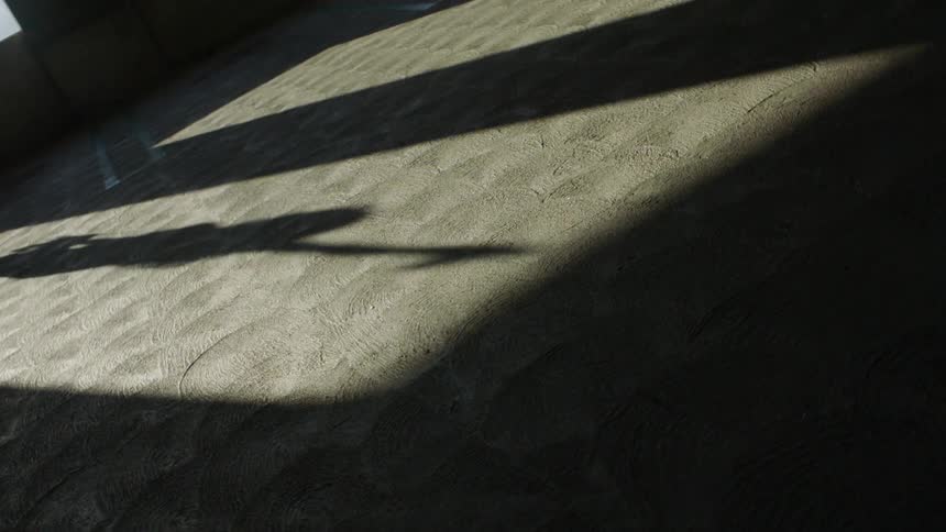 A shadow is moving on the ground