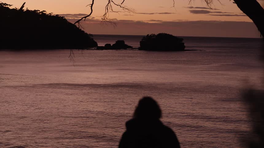 A woman standing out near the coast