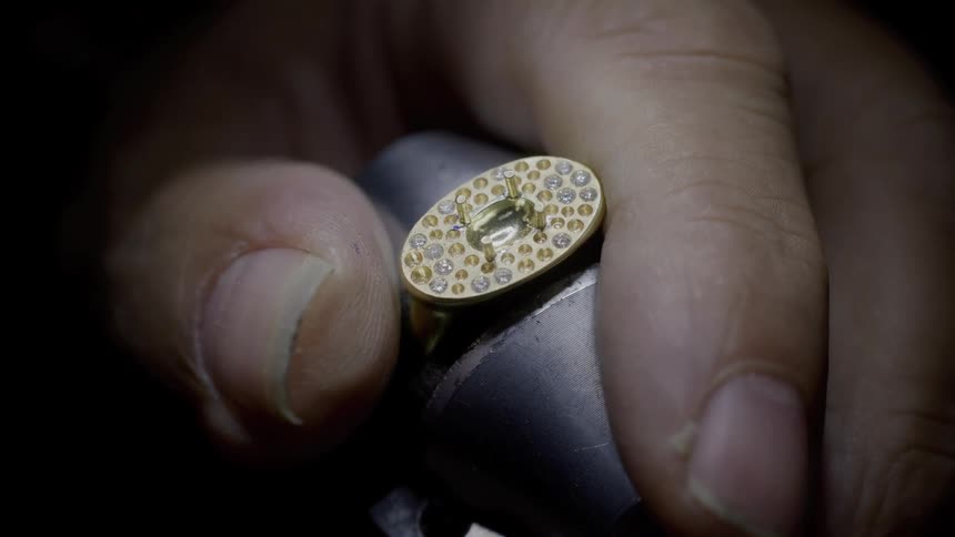 Jewelry adjusted in precision clamp by human hand