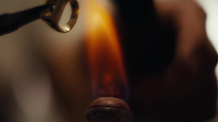 A person working on a ring in a factory