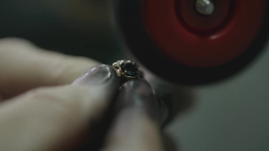 A person polishing a ring in a factory