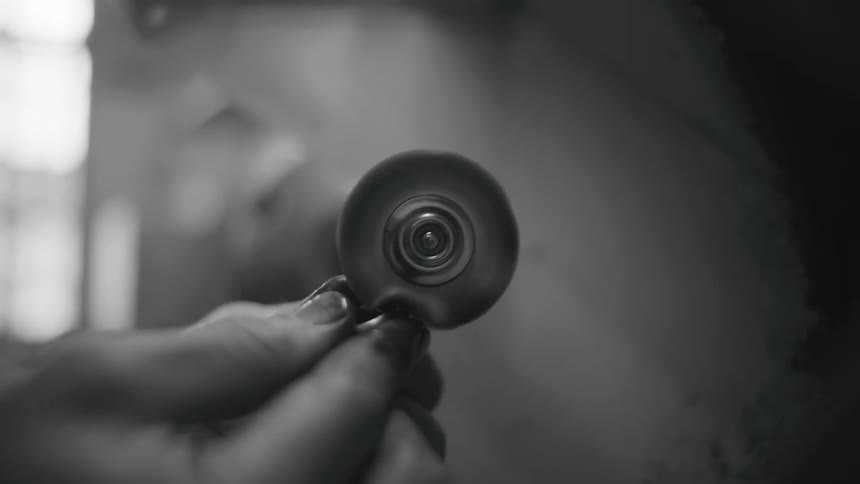 A person polishing a ring in a room