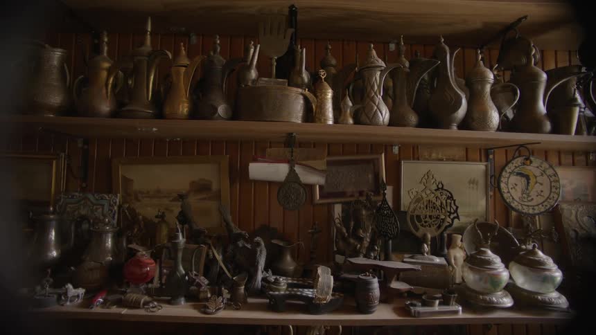 The shelves are covered with pitchers and vases