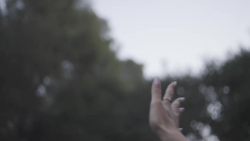 A hand of a person with a ring wiping around