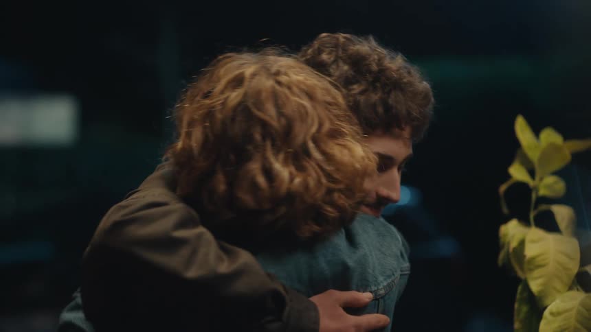 The couple hug as they greet at the doorway