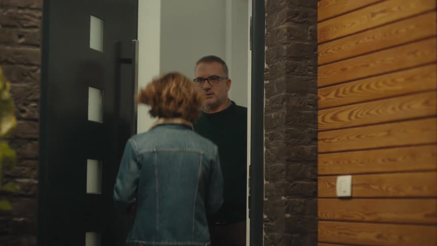 A young couple shares a romantic moment and nearly kisses at a doorstep until a man appearing to be the girls father abruptly opens the doorthe girl quickly heads inside while the man gives the boy a stern lingering look before closing the door