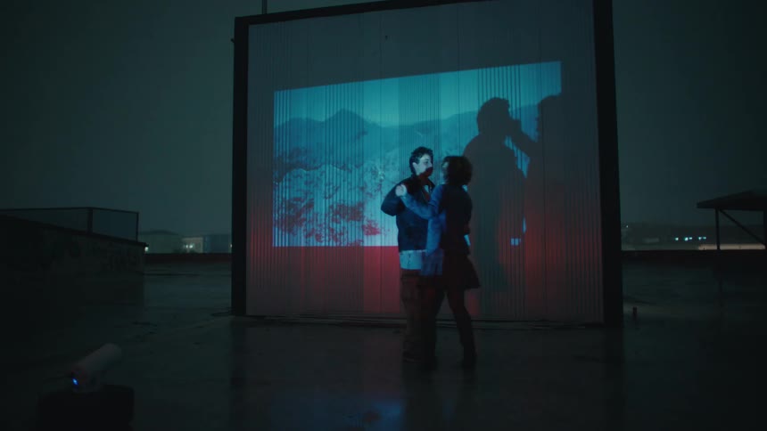 Two people dance in a room