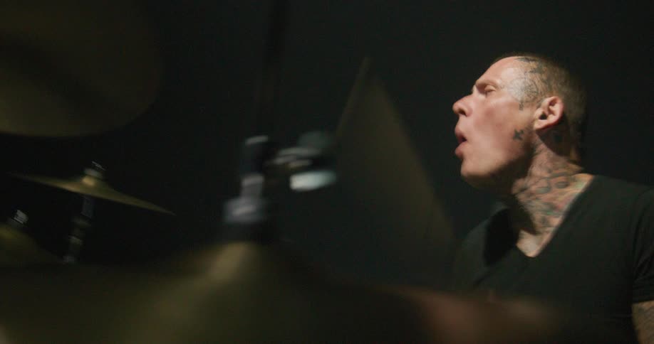 A man playing drums in a room