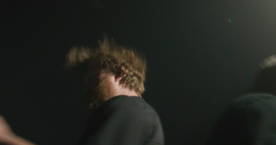 Two musicians playing electric guitar during a live performance on a concert stage
