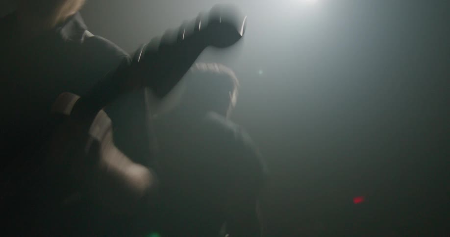 Two guitarists are playing electric guitar on a stage