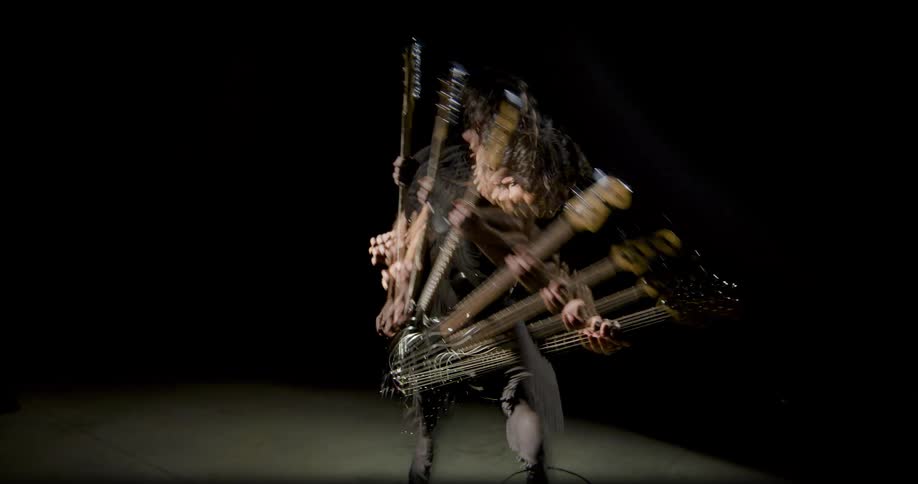 A man with a guitar poses for photos