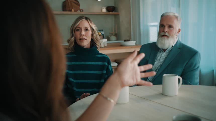 A man and woman talking to another woman