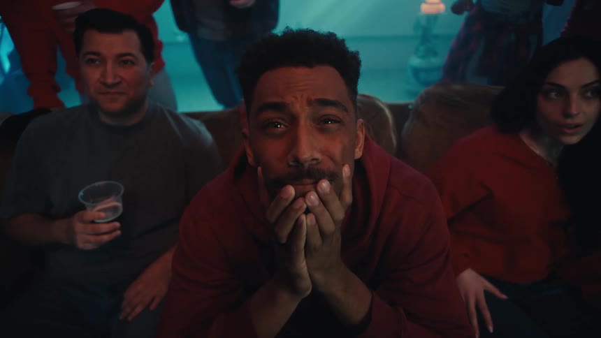 People at a party get upset by something they are watching