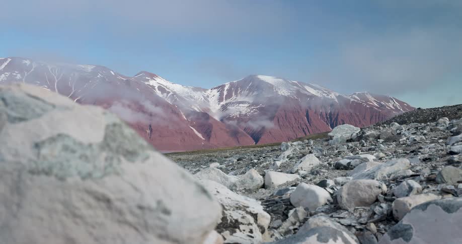 Red mountain peaks are covered in snow