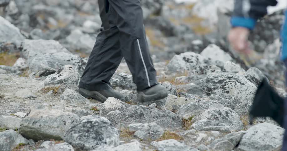 The hikers move over the rocks on the hill