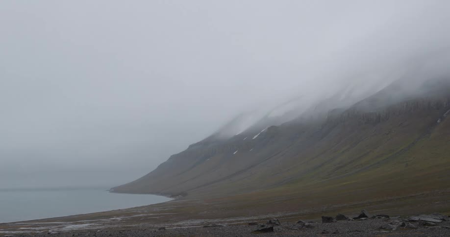 Heavy fog covers the shore line and mountains